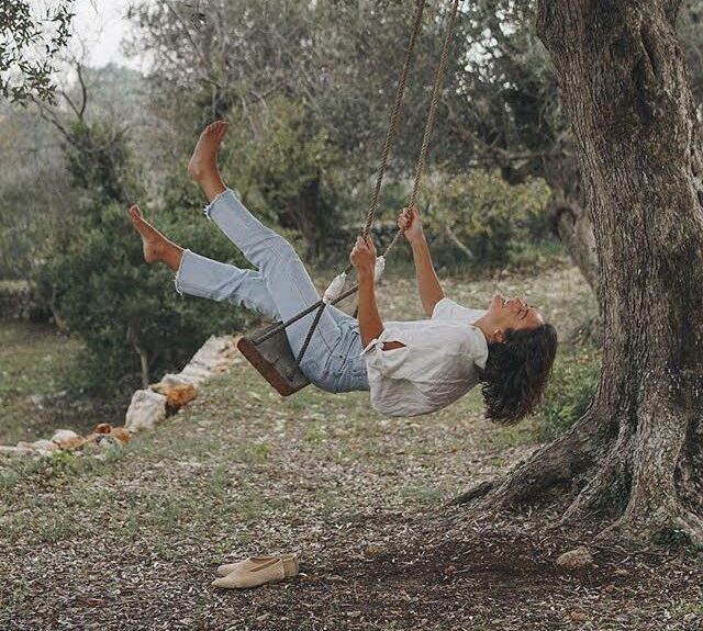 how to set rest relax goals - woman enjoying swinging