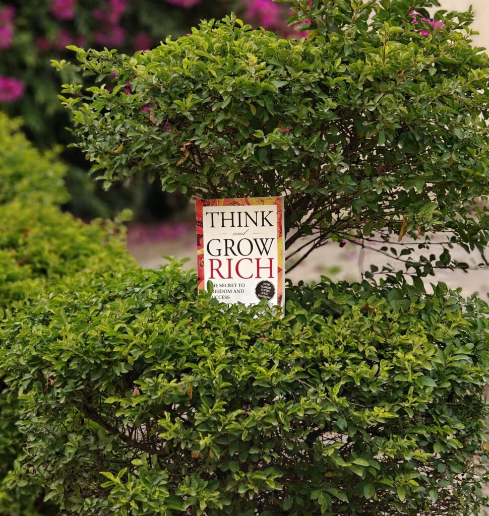 "Think and Grow Rich" book on an ever-growing bush.