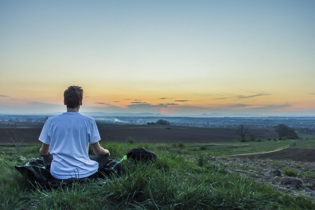 A person sitting calmly in a relaxed pose, embodying peaceful meditation techniques for beginners.