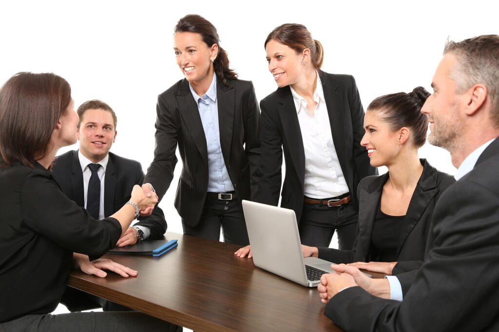 A happy team celebrating, showing how to manifest a successful business together.