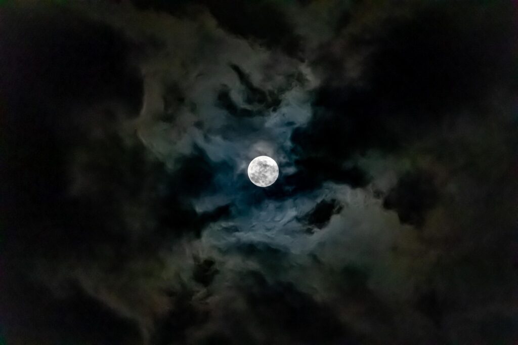 A bright full moon shines in a dark night sky with stars, showing what it looks like before the New Moon Solar Eclipse in Aquarius 2026.